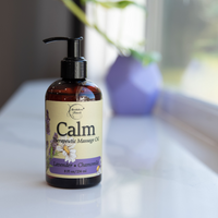 Calm Therapeutic Massage Oil on a window sill.