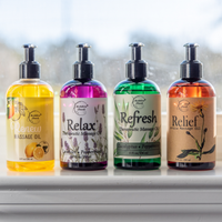Mega Massage Oil Bundle on window sill; Renew, Relax, Refresh, and Relief Massage Oils