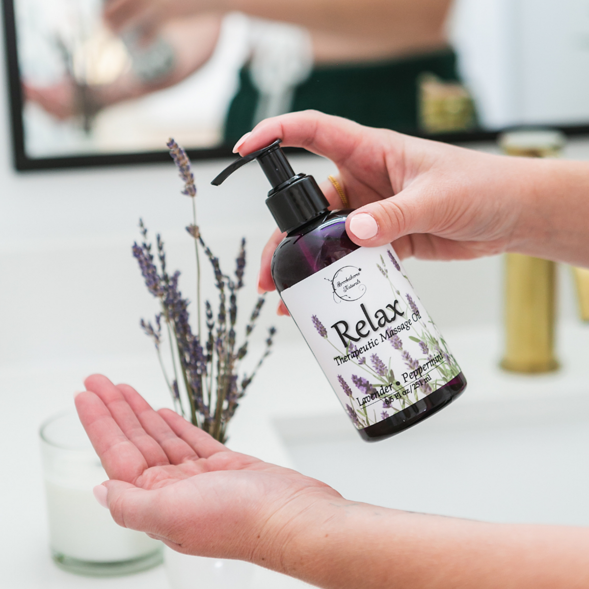 Relax Therapeutic Massage Oil being pumped into a persons hands