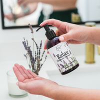 Relax Therapeutic Massage Oil being pumped into a persons hands