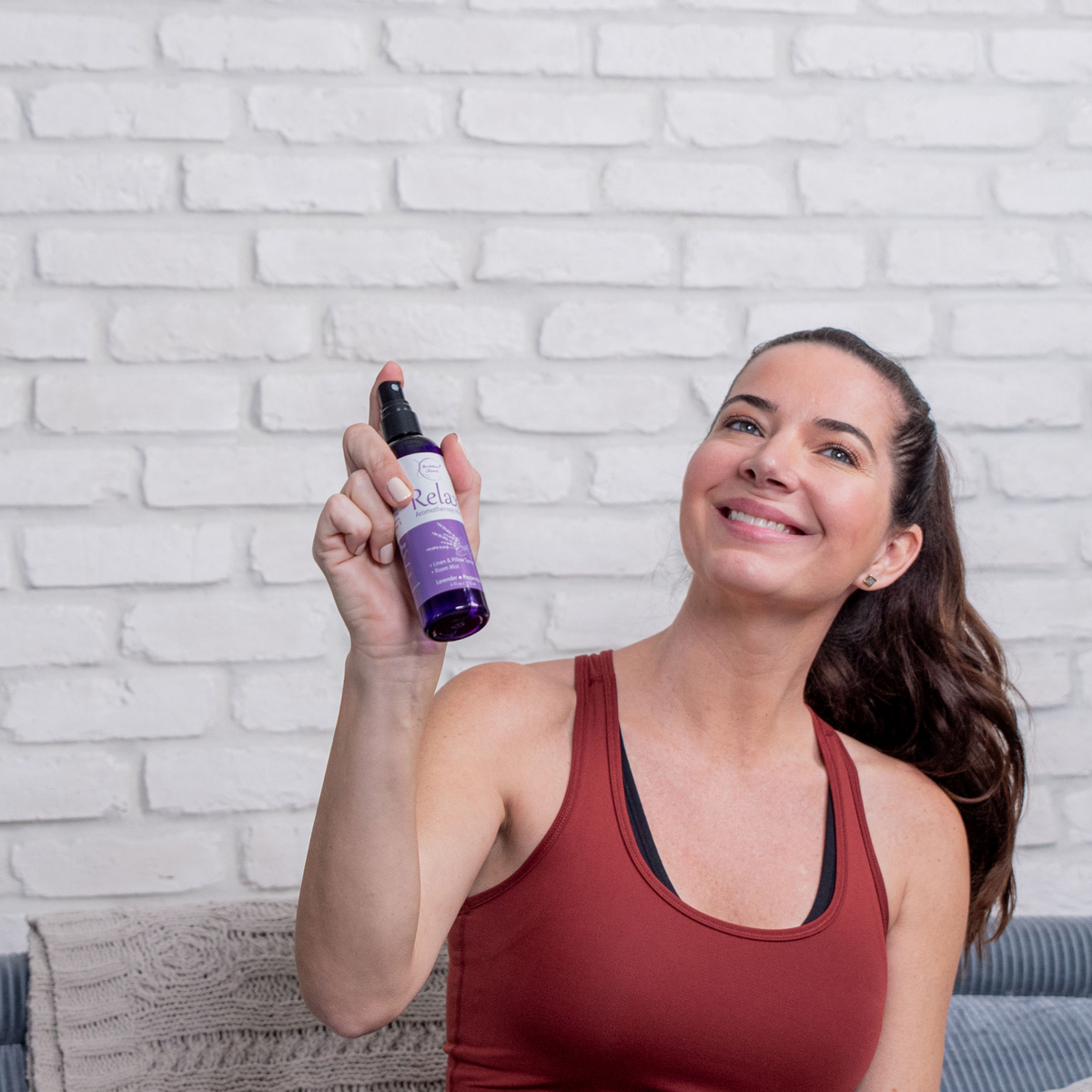 Woman spraying Relax Aromatherapy Mist into the air 
