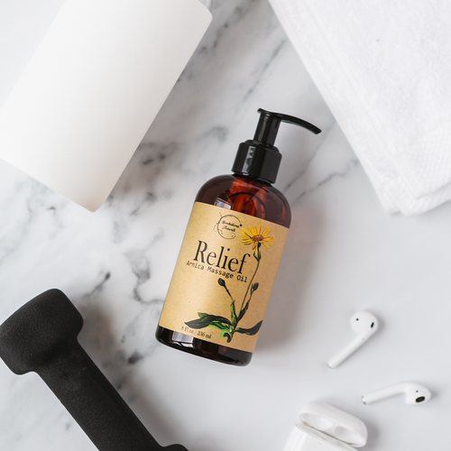 Relief Arnica Massage Oil on a granite countertop table with workout accessories