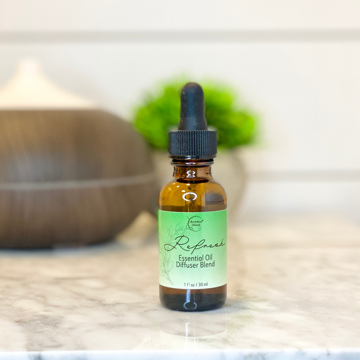 Refresh Essential Oil Diffuser Blend with a diffuser in the background