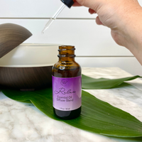 Relax Essential Oil Diffuser Blend being dropped into a diffuser