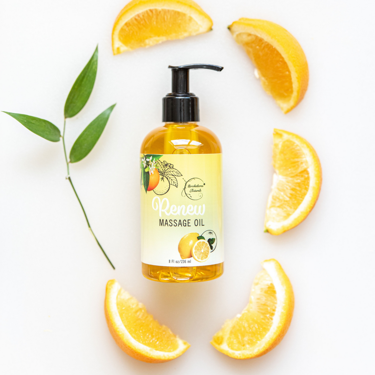 Renew Massage Oil pictured with oranges